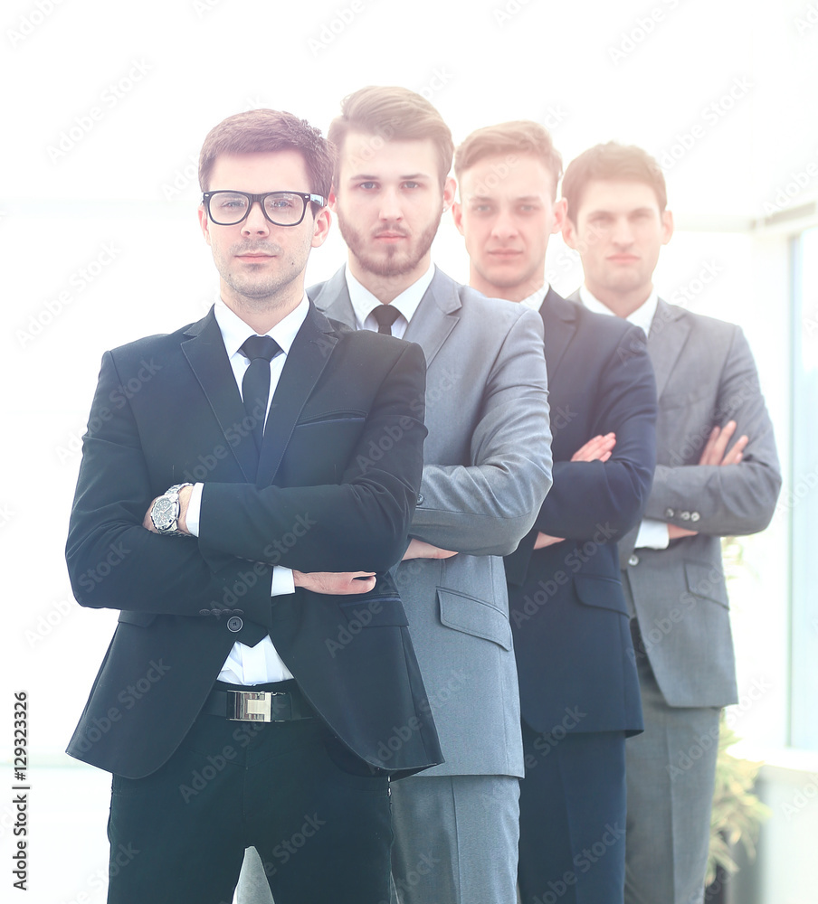 Business team in a line smiling at the camera Business team in a line smiling at the camera