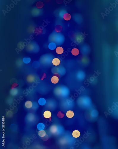 abstract blurred image. New Year, Christmas decorations, lights and silhouette . Christmas tree lights in different color. No focus, soft lines, bright festive colors. 