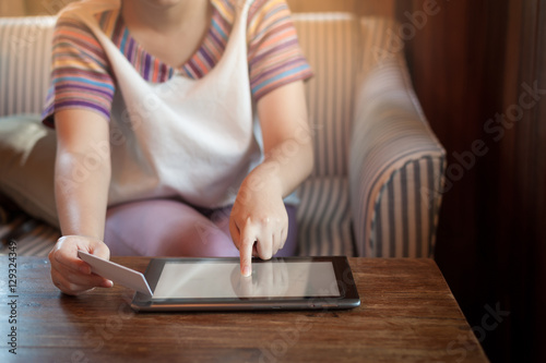 Woman using phone for on line payment