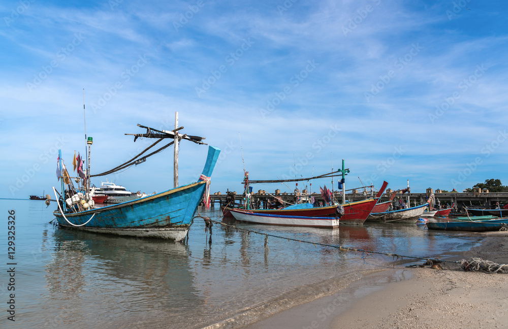 The old fishing boats moored along the shore.