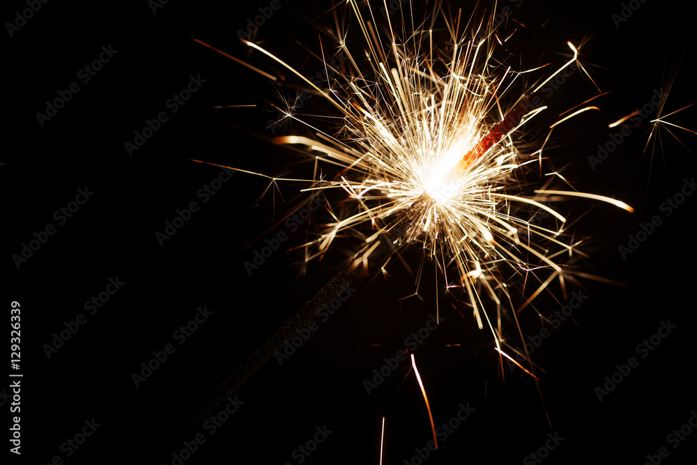 Closeup Bengal light - burning sparkler. Hand-held firework that burns slowly while emitting flames and sparks.