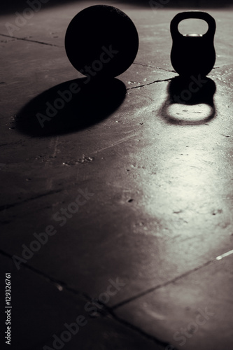 Kettlebell and ball backlight and shadow in gym