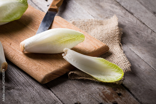 Top view on endive lying on wooden background. photo