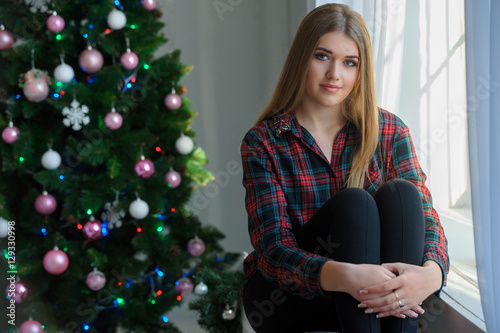 portrait of a beautiful young girl near the window and Christmas © sasapanchenko