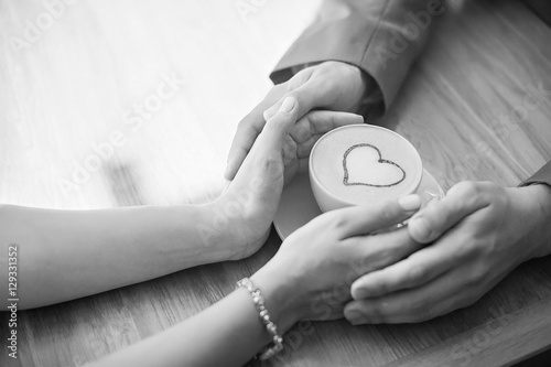 lovers are holding a Cup of coffee