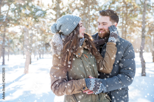 Couple looking at each other in winter park photo