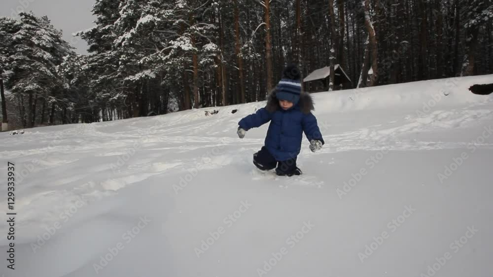 little boy is playing in the snow little boy is playing in the snow