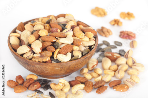 Mixed nuts: Pistachios, peanuts, walnuts, almonds, hazelnuts, Brazil nuts, pumpkin seed and cashews in wooden bowl