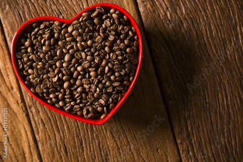 Coffee love concept. Coffee beans in heart into the bown