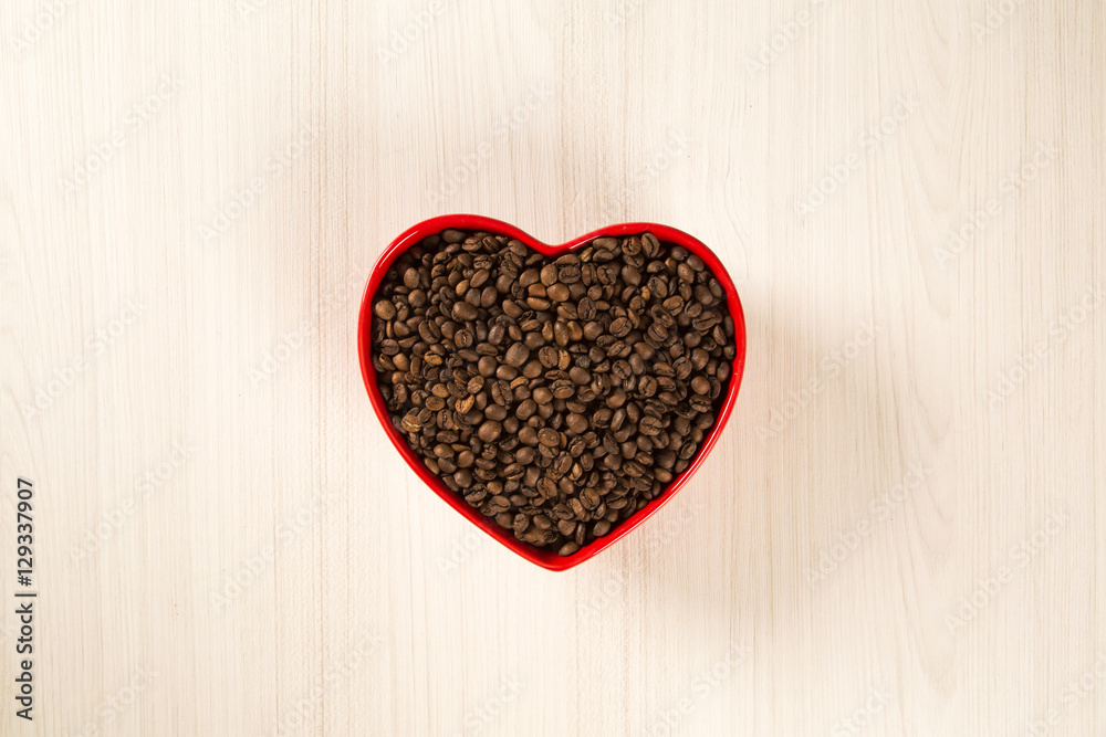 Coffee love concept. Coffee beans in heart into the bown Coffee love concept. Coffee beans in heart into the bown
