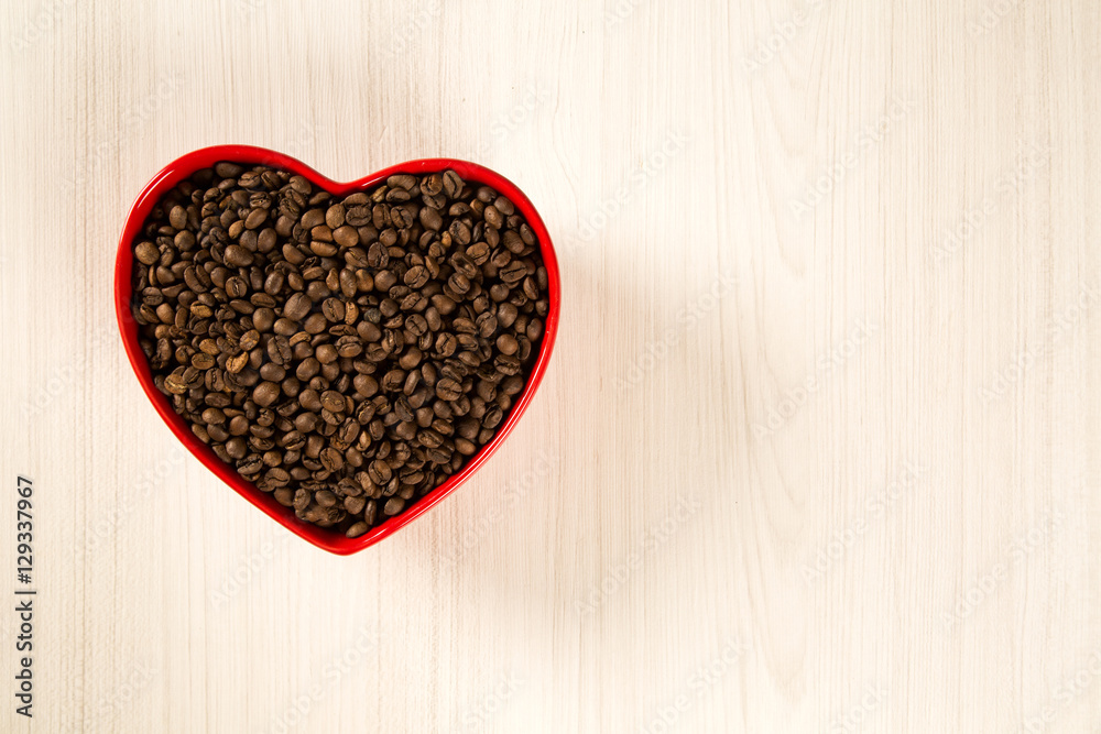 Coffee love concept. Coffee beans in heart into the bown Coffee love concept. Coffee beans in heart into the bown
