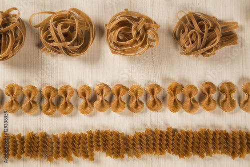 Variety of types and shapes of dry Italian integral pasta