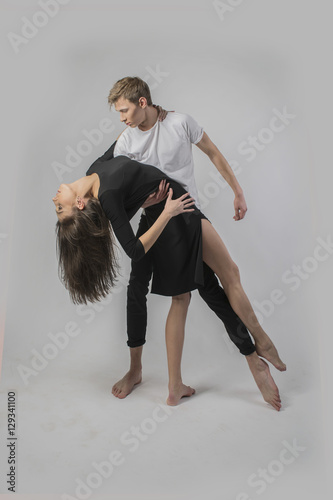 couple dancing on a white background. A guy and a girl in dance movement
