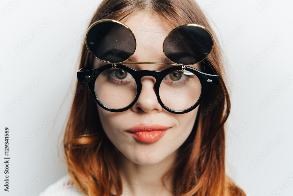 Portrait of a girl in glasses on a light background
Portrait of a girl in glasses on a light background