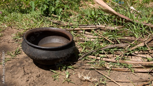 Utensil partially filled with water kept on the ground