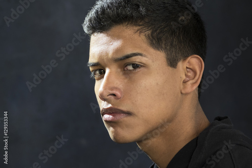 Portrait of a young hispanic man, looking upset
