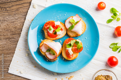 Bruschetta with tomato, cheese and bacon
