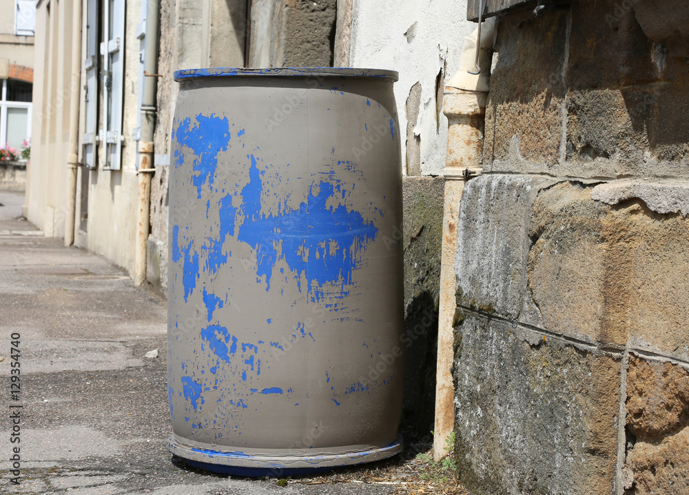 old blue plastic barrel at th street old blue plastic barrel at th street