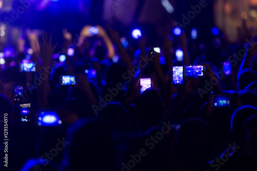 Hand with a smartphone records live music festiva © ververidis