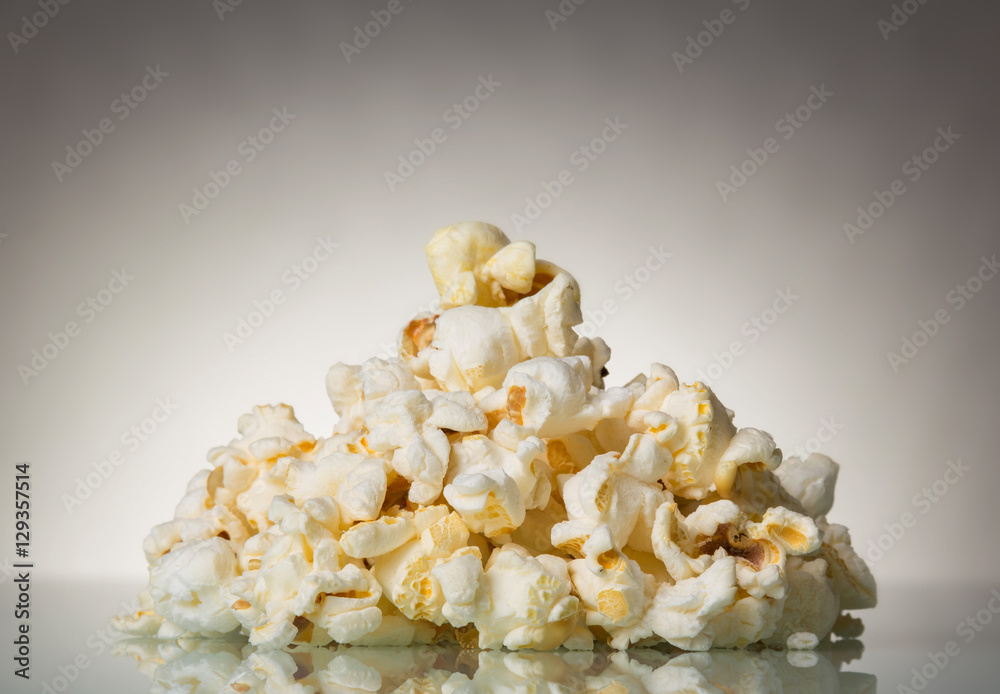 Pieces of salty popcorn on a gray