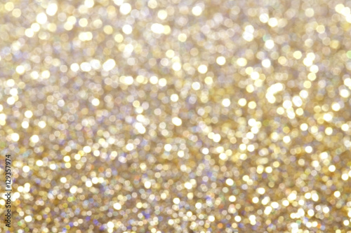 Glitter and glow soft gold bokeh shining light abstract dreamy sparkle background