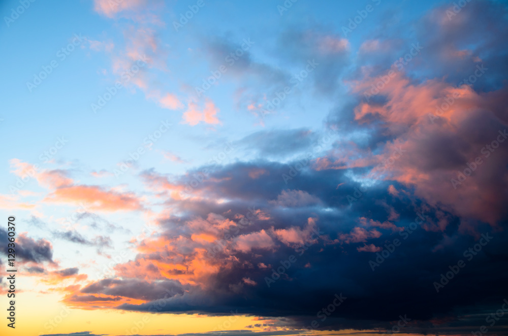 Beautiful bright sunset sky with fluffy clouds