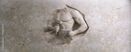 epic background of athletic man cuts his body of marble stone photo