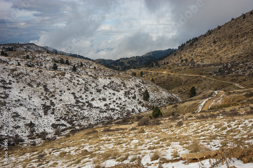 Winter mountain snowy landscape near ski center on mount Helmos, photo