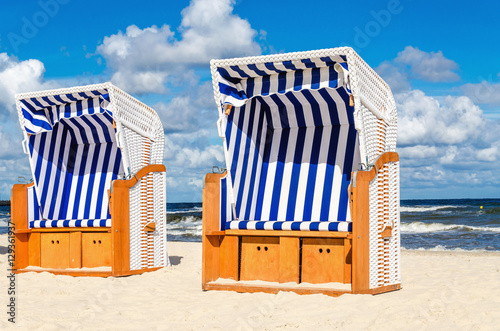 Wicker chairs on sandy Kolobrzeg beach by Baltic Sea, Poland photo