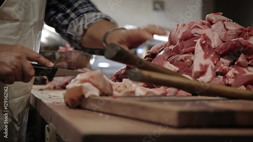 Making of hungarian sausage, slicing pork raw meat photo