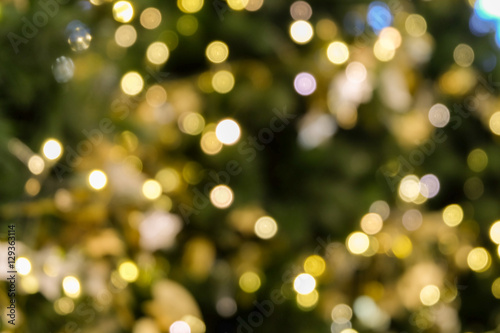 christmas tree bokeh light in green yellow golden color, holiday abstract background, blur defocused