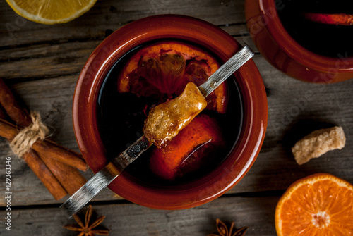Traditional German Christmas drink Feuerzangenbowle, analogue of mulled wine: hot wine with orange, lemon and spices, complemented by burning sugar and rum