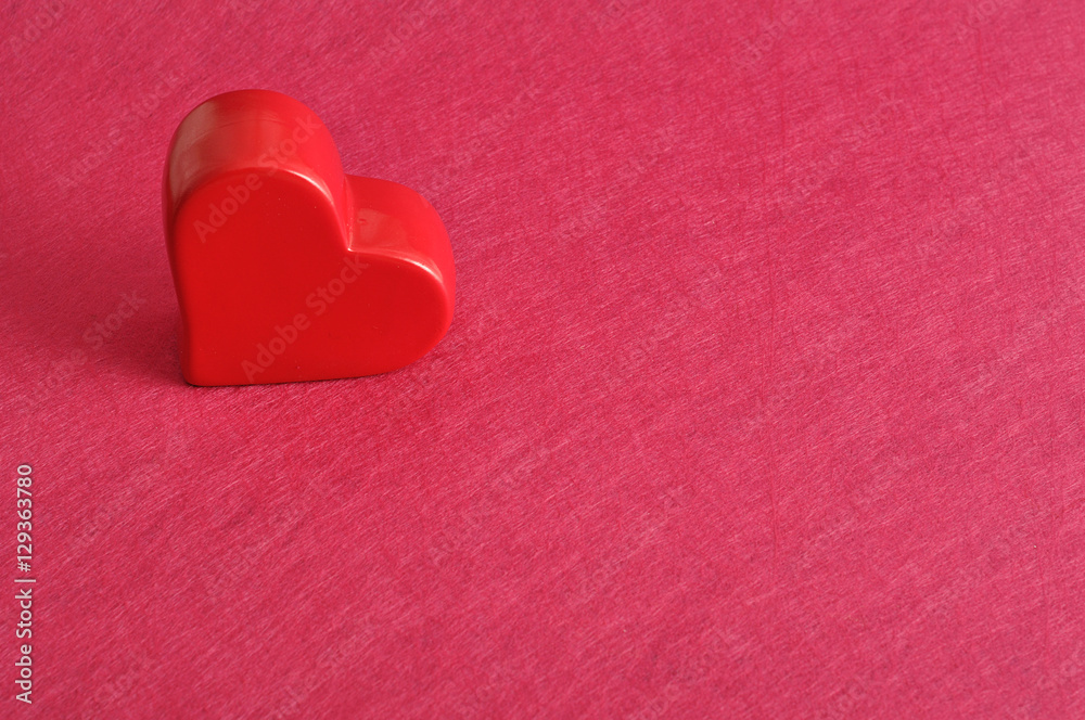 Fototapeta premium Valentine's Day. Red heart isolated against a pink background