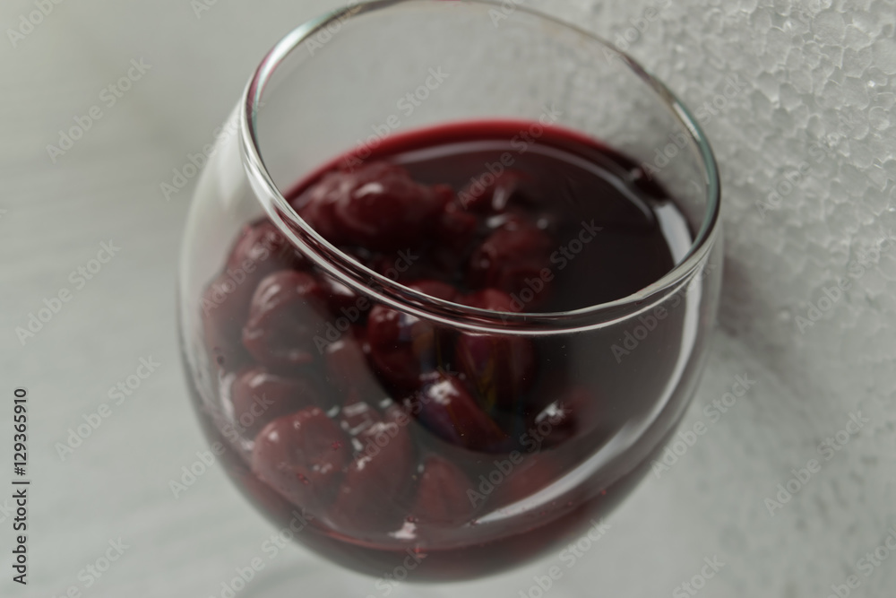 Cherry jam close up of a wine glass on a light background Cherry jam close up of a wine glass on a light background