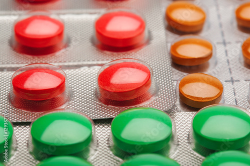 Colored pills in a plastic silver boxes