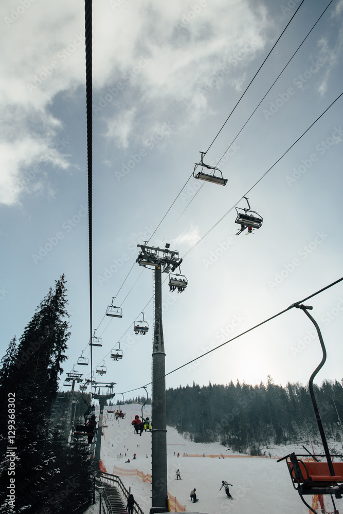 The lift for skiers in the winter mountains.