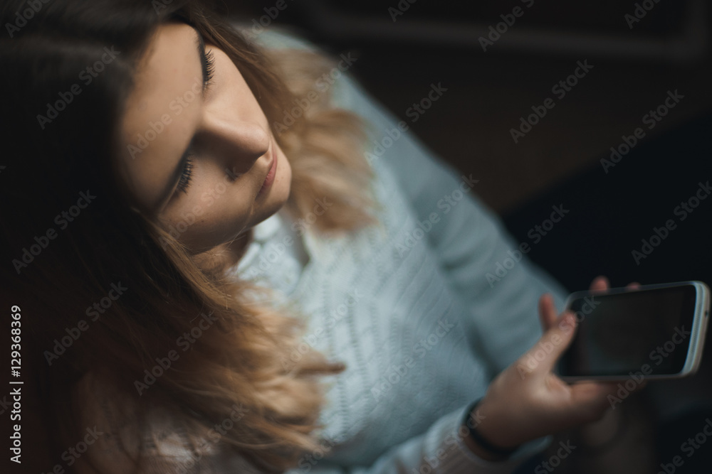 Teen girl excessively sitting at the phone at home. he is a victim of online bullying Stalker social networks Teen girl excessively sitting at the phone at home. he is a victim of online bullying Stalker social networks