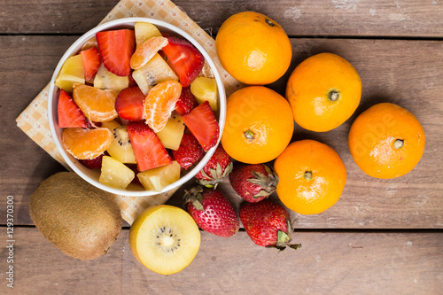 ftuits salad on the wood background. photo