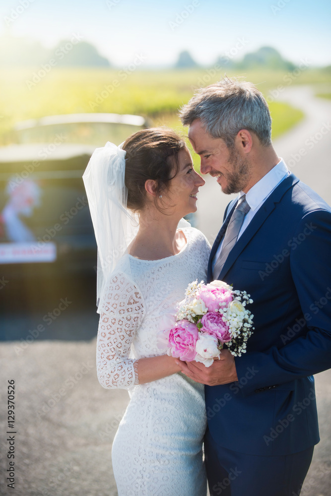  portrait of  newlywed smiling, entwined on a country road g