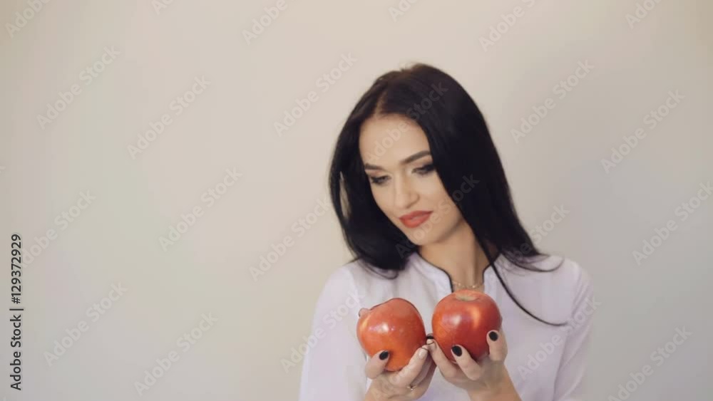 Cute girl posing with two juicy apples and smiling to camera 4K Cute girl posing with two juicy apples and smiling to camera 4K