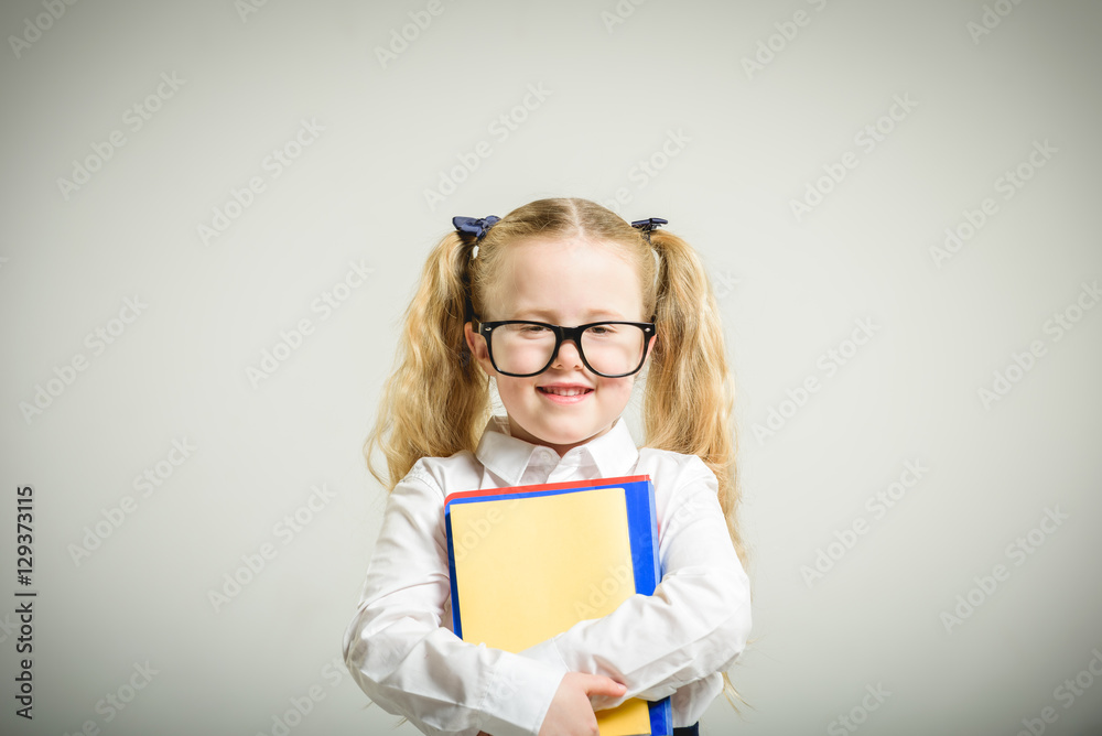 Schoolgirl in glasses reaching toward the school. Schoolgirl in glasses reaching toward the school.