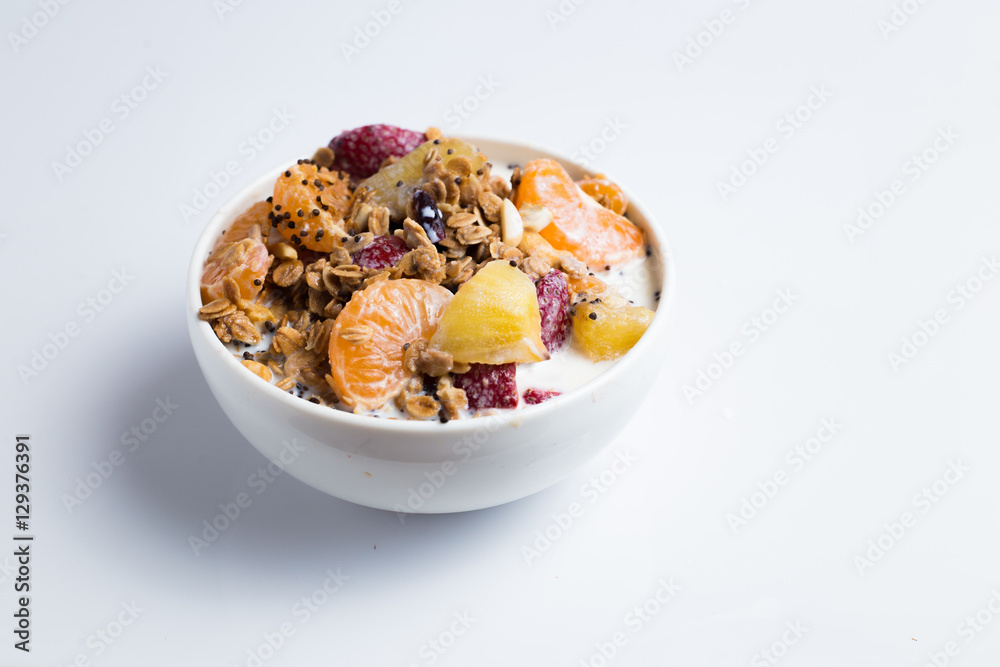 granola with ftuits salad on the white background. granola with ftuits salad on the white background.