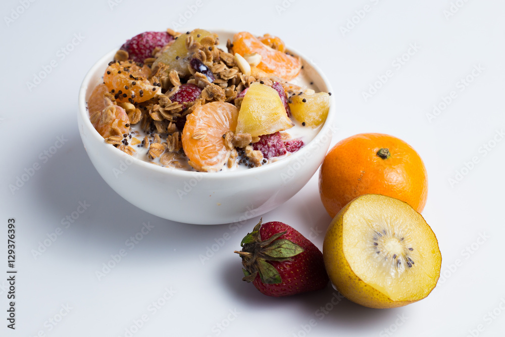 granola with ftuits salad on the white background. granola with ftuits salad on the white background.