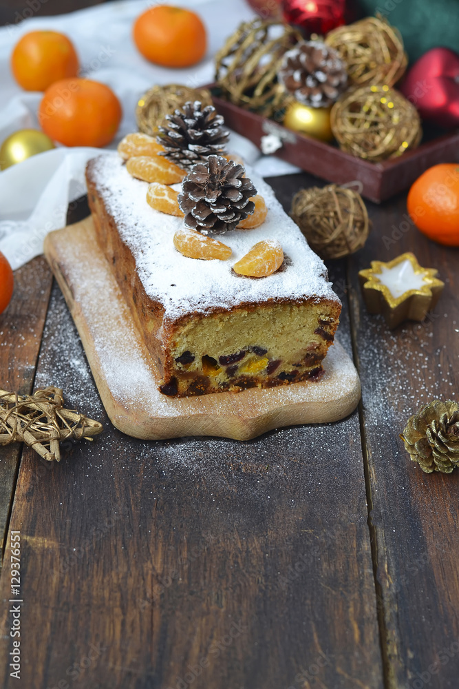 Fototapeta premium Christmas cake with dried fruits and tangerines