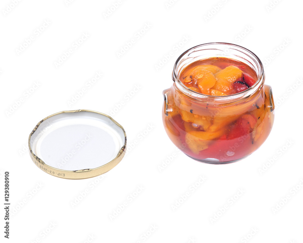 Fire roasted yellow and red peppers in jar isolated on white background Fire roasted yellow and red peppers in jar isolated on white background