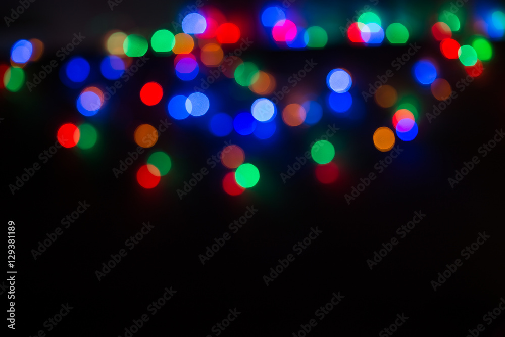 Christmas background.blurry red green and blue lights on a black