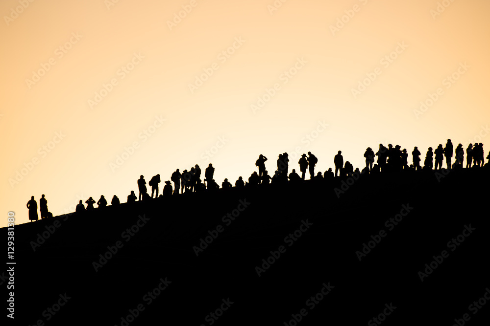People enjoy sunset on the dunes