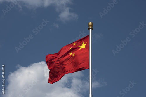 Flying Chinese National Flag against blue sky