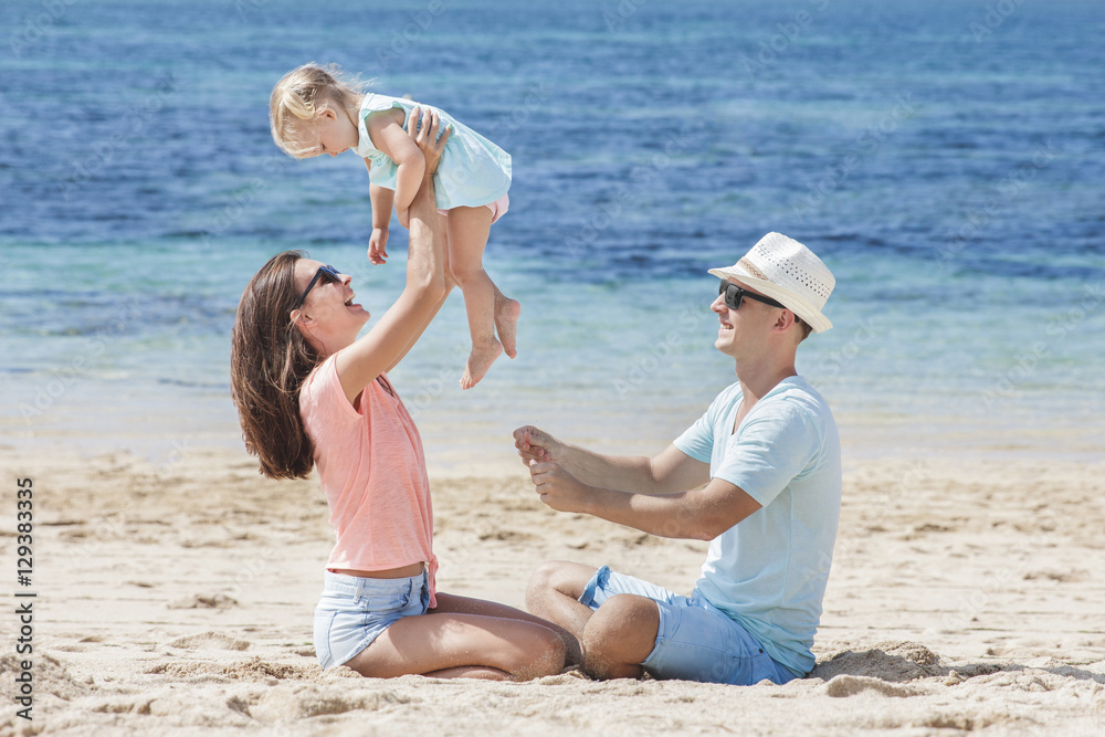 joyful little family having fun together on the beach joyful little family having fun together on the beach