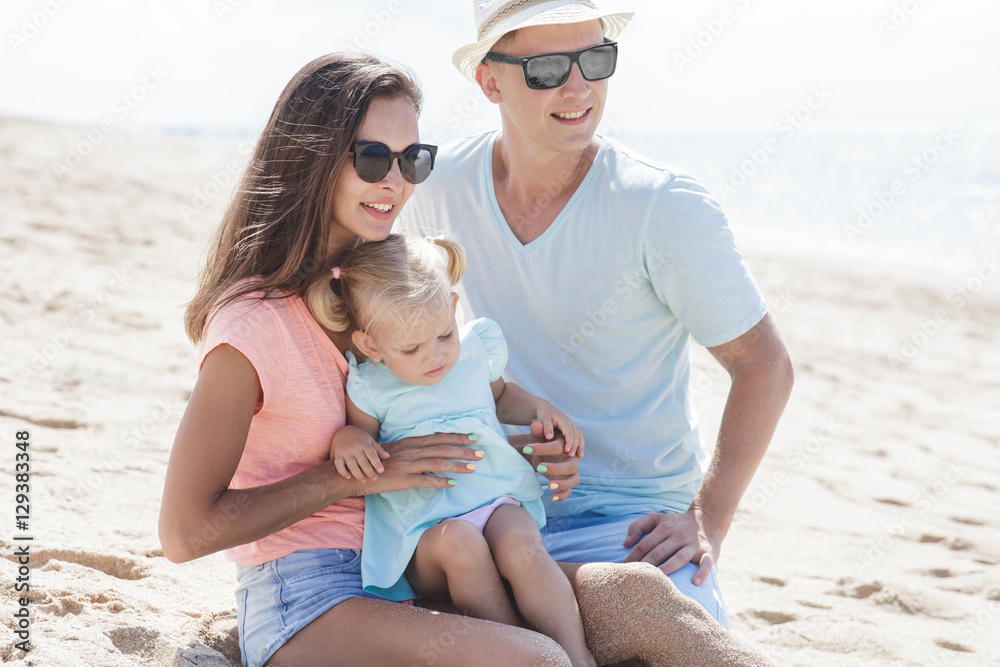 joyful little family having fun together on the beach joyful little family having fun together on the beach